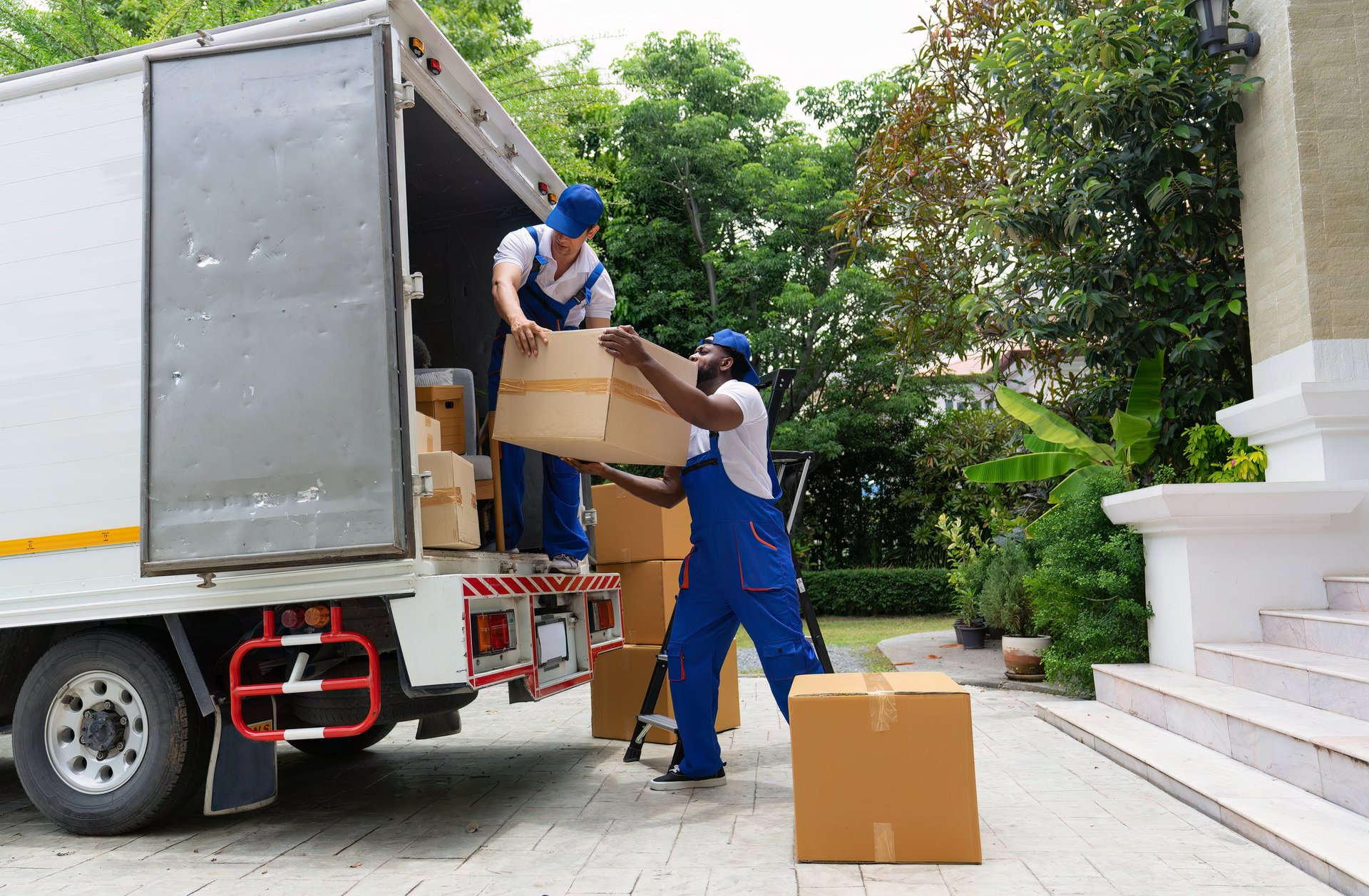 Professional movers loading truck with furniture