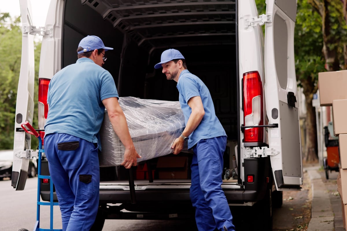 Professional movers carefully loading furniture